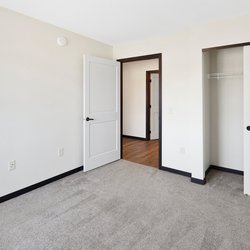 carpeted bedroom at Rivertown Residential Suites located in Monticello, MN